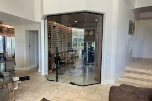 Elegant glass wine cellar with custom mirror and wood accents for sophisticated home bar.