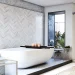 Bright modern bathroom with glass shower enclosure and stylish mirror accent.