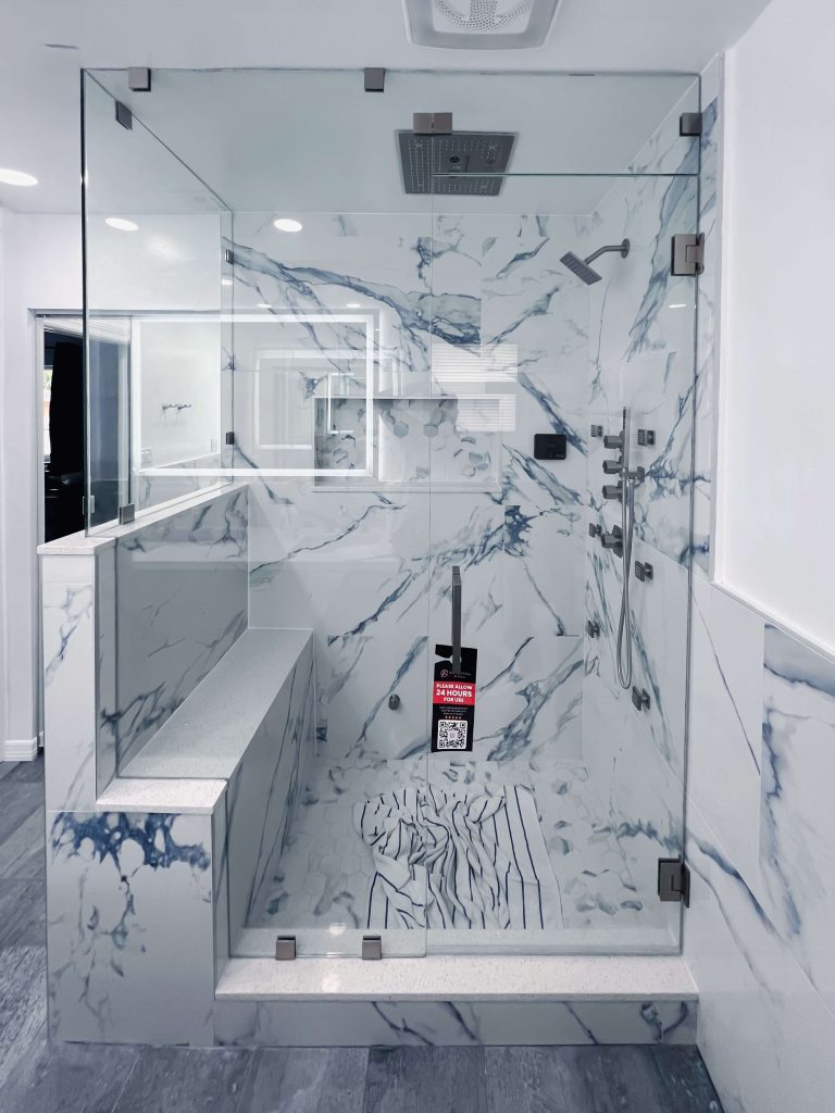 High-quality glass and marble bathroom shower with modern fixtures.