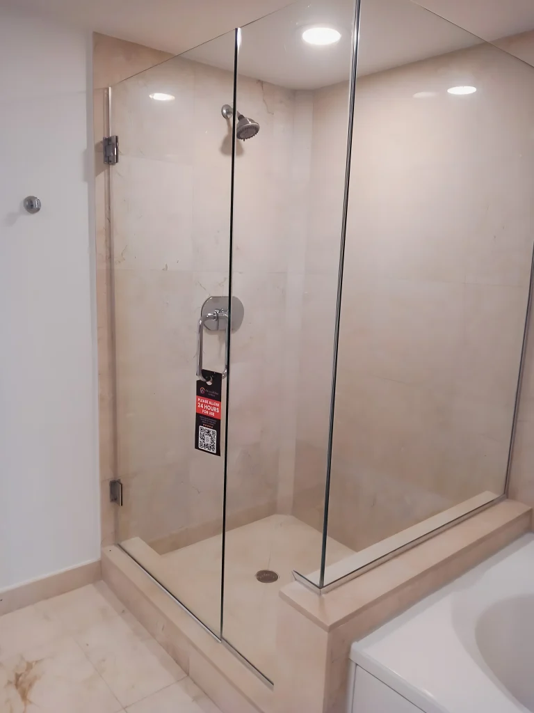 High-quality glass shower enclosure with sleek hardware. Custom mirrors and glass for bathrooms.