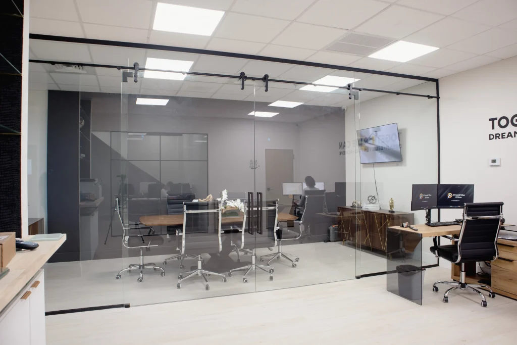 Elegant glass office partition with sleek black framing for modern workplaces.