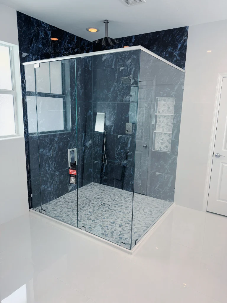 Frameless 90 degree corner shower enclosure with matte black hardware, Piping Plover Road residence