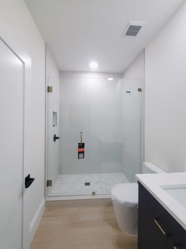 High-quality glass shower enclosure with sleek design. Durable mirror installation enhances bathroom aesthetics.