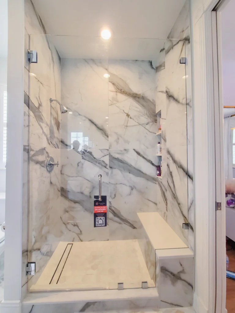 High-end glass shower enclosure with marble accents for luxurious bathrooms.
