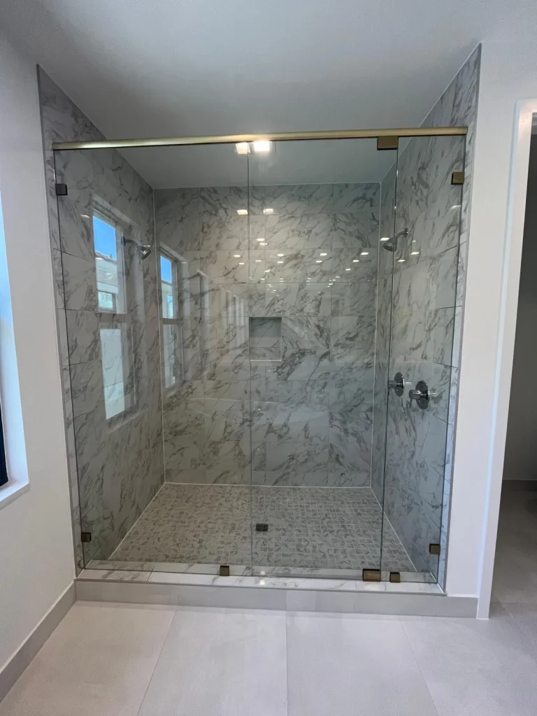 High-quality glass shower enclosure with marble walls.