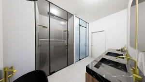 Modern glass shower and sinks with black marble countertops.
