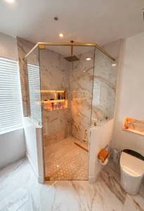 High-quality glass shower door with elegant marble accents.