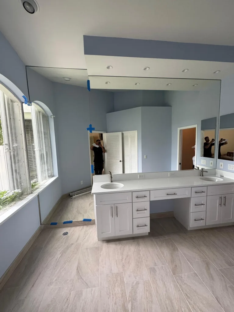 Large bathroom mirror reflecting the room's interior.