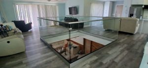 Beautiful glass floor display in living room for modern aesthetic.