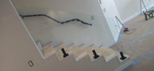 Beautifully crafted glass and mirror installation in a modern staircase setting, enhancing home decor.