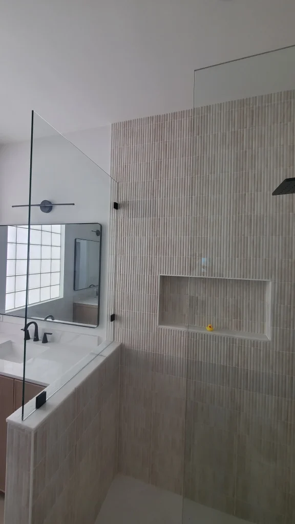High-quality crystal glass shower door with sleek design. Custom glass & mirror solutions for bathrooms.