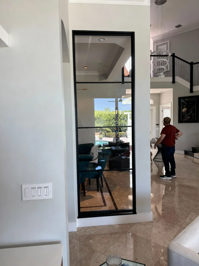 Stunning floor-to-ceiling glass and mirror door for stylish interior design.