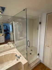 High-quality glass shower door with stainless steel handle accessory.