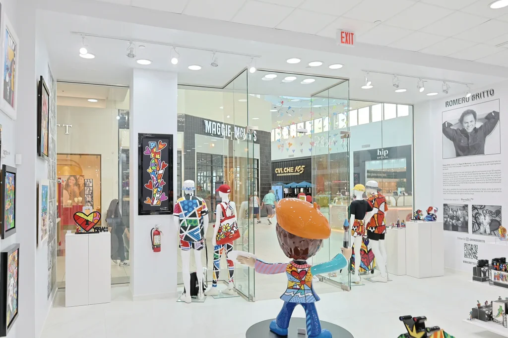Vibrant glass and mirror artworks in modern art store display.