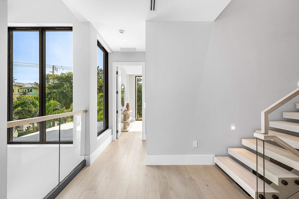 Modern glass and mirror accents enhance the interior of the Duplex Andrews Ave project.