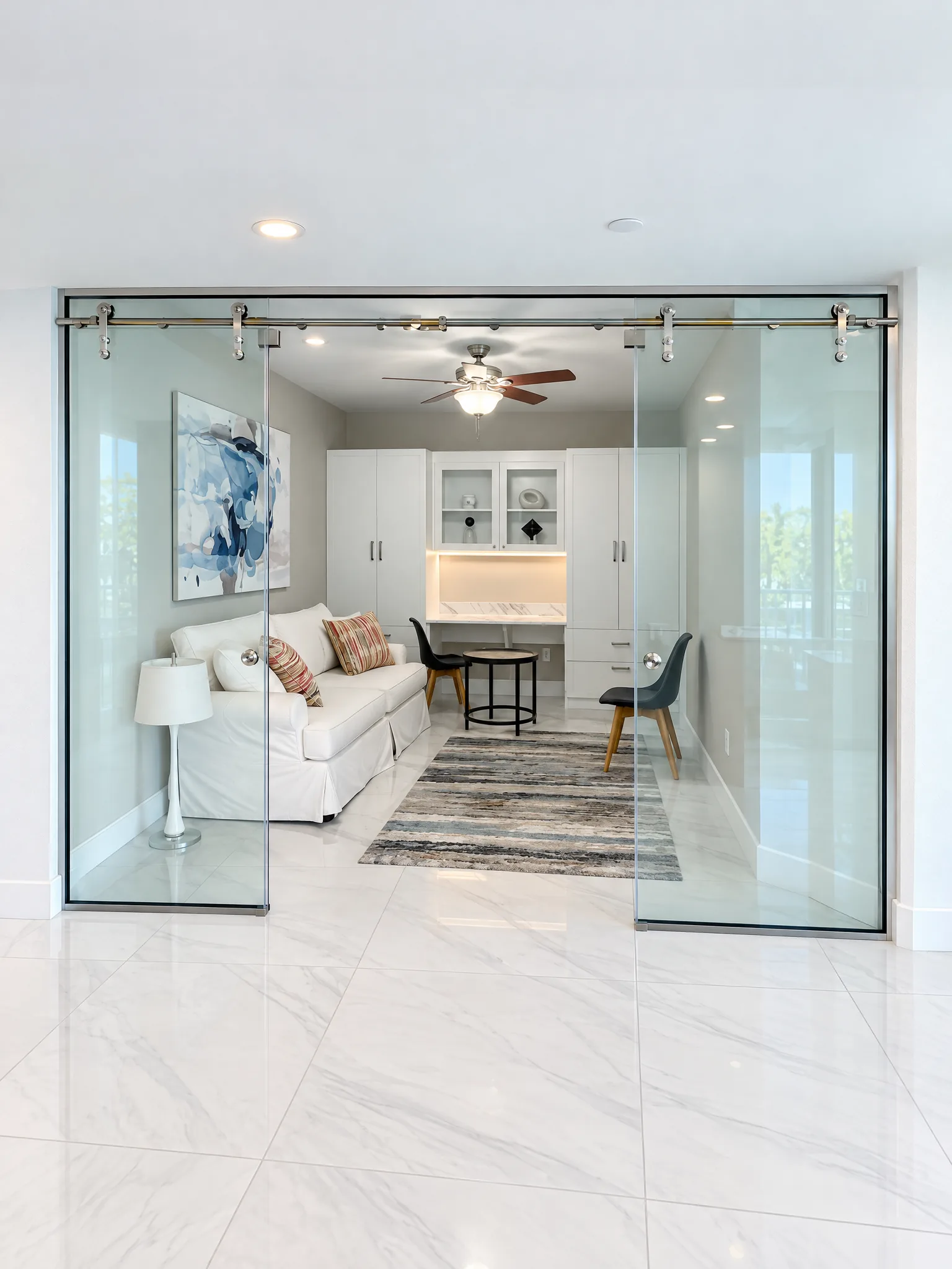 Frameless sliding glass wall closing off a living room