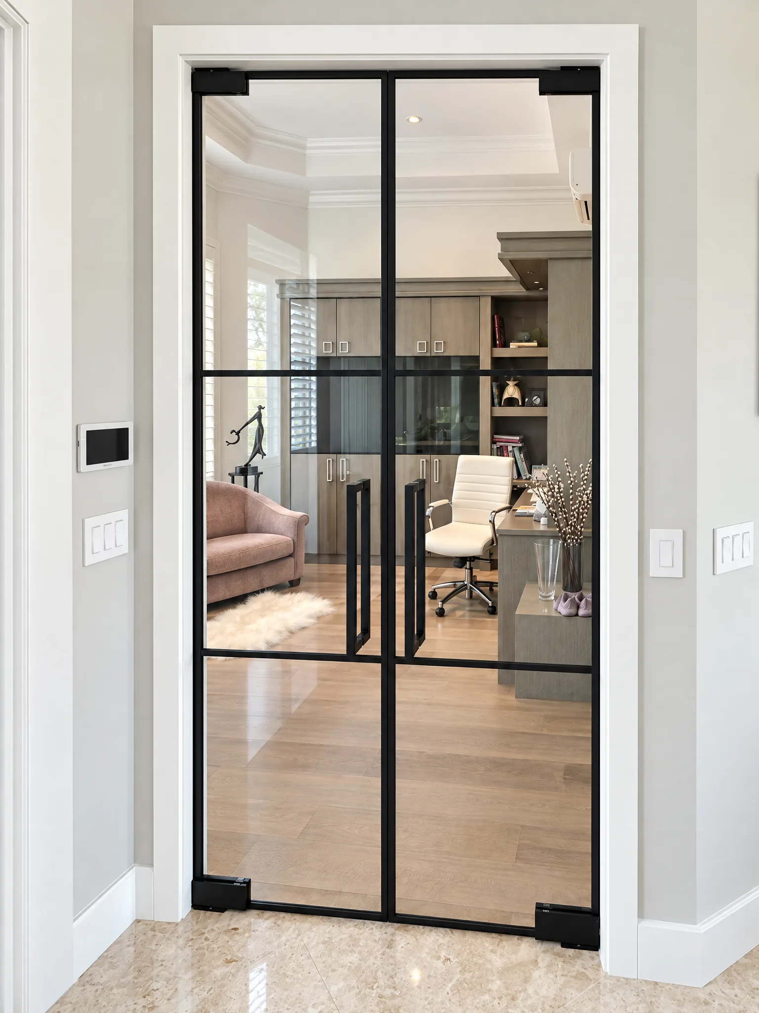 Black grid glass partition double doors in front of a home office