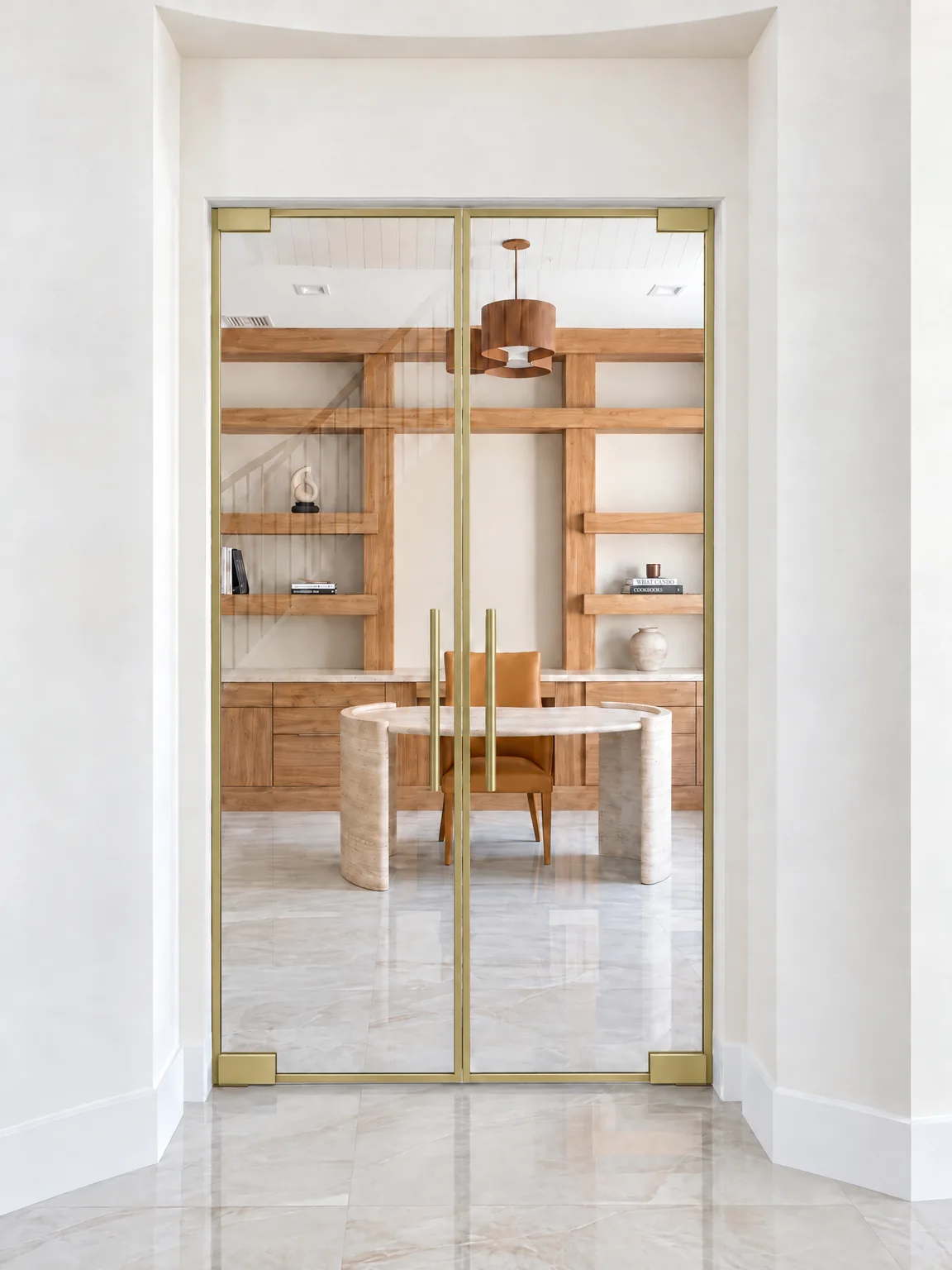 Perimeter glass partition double doors in brushed gold