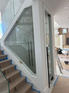 Glass wine cellar under the stairs
