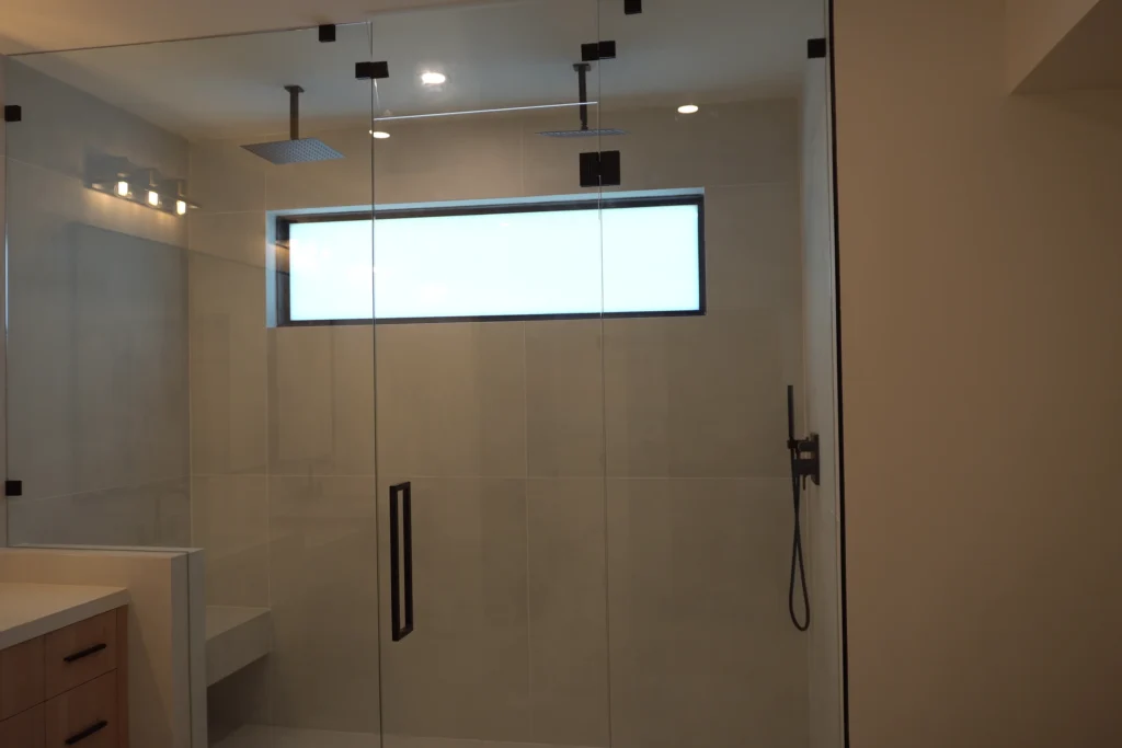 Frameless clear glass master shower enclosure with matte black hardware, Breakers West Blvd, West Palm Beach