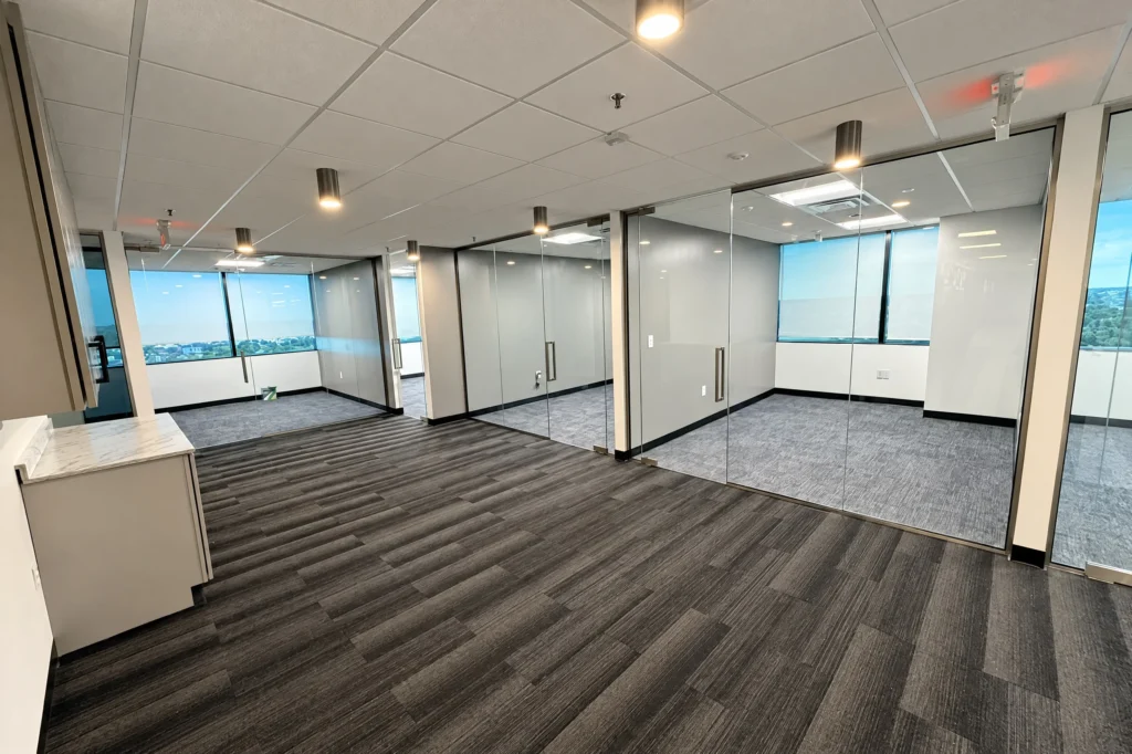 Frameless glass office partitions with brushed nickel frames by ACG Glass & Metals in West Palm Beach