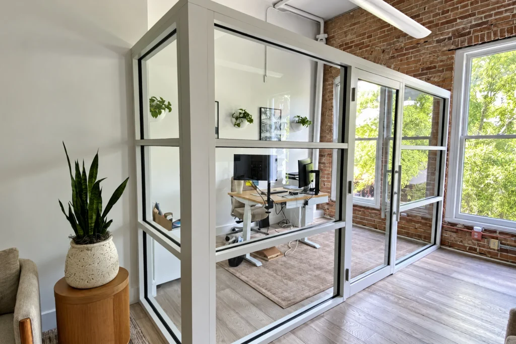 Interior storefront partition with white aluminum frames and clear tempered glass in a Clematis Street office, West Palm Beach