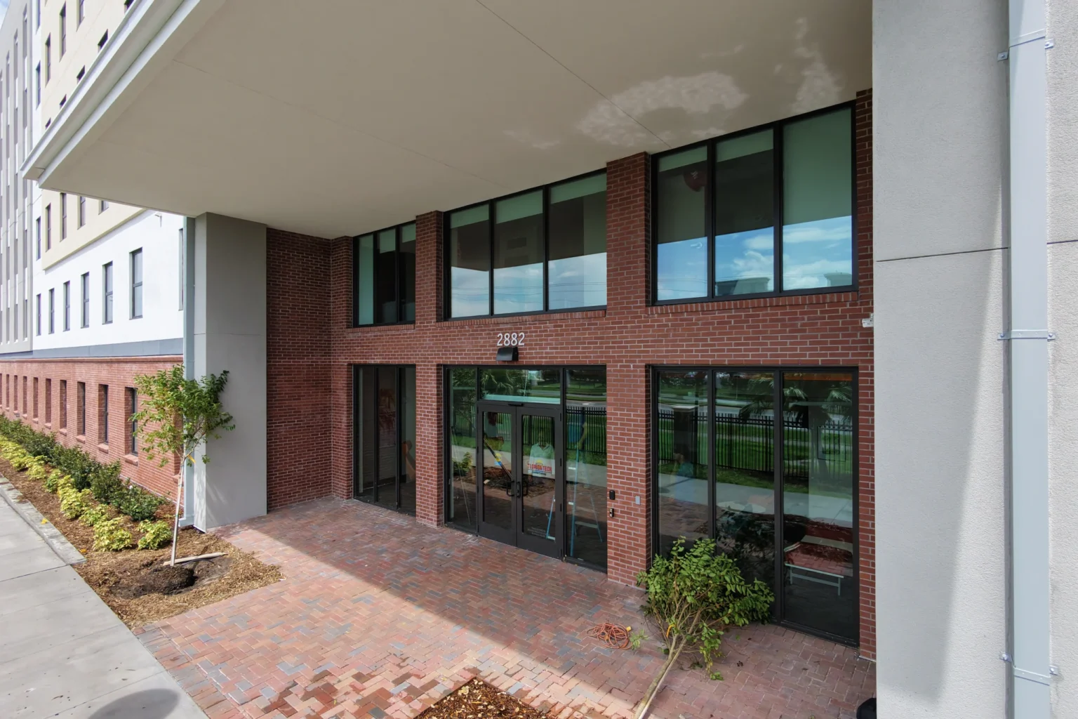 Bronze impact storefront doors at Crimson Crossing student housing, Florida Tech in Melbourne