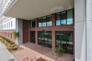 Bronze impact storefront doors at Crimson Crossing student housing, Florida Tech in Melbourne