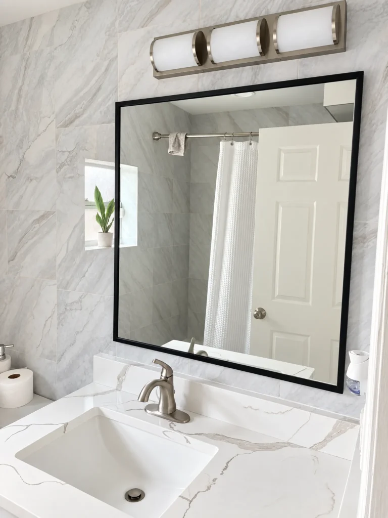 Black framed vanity mirror over a marble countertop, 17th Street residence