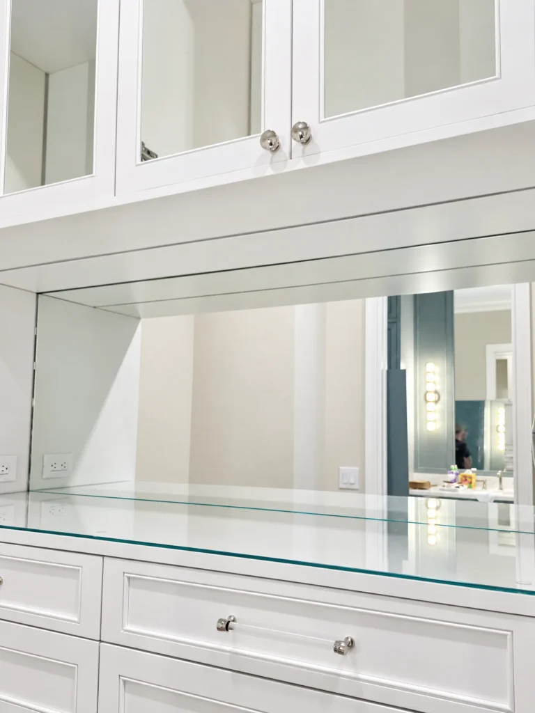 Closet mirror above a glass-topped dresser, Marsh Cove residence, Palm Beach Gardens