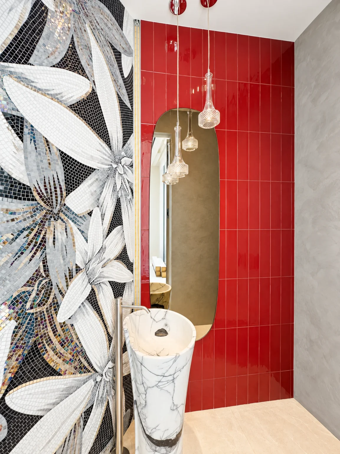 Tall pill-shaped mirror in a powder room with red tile