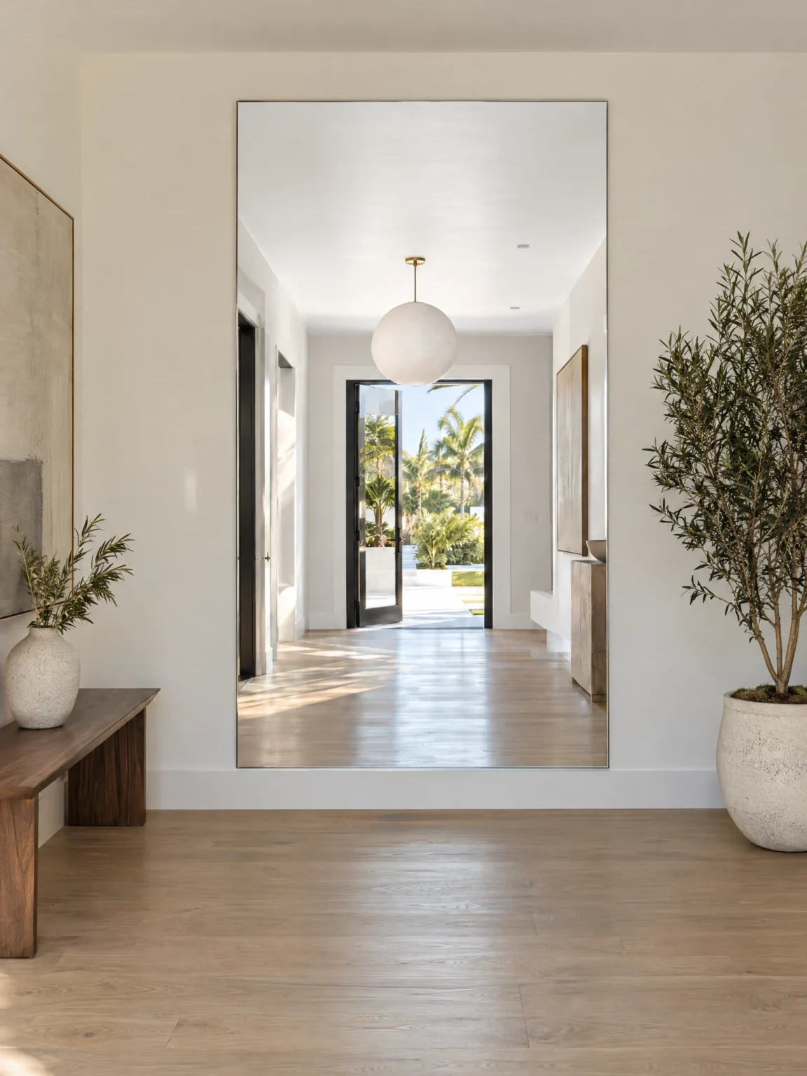Full-height low iron mirror on a bright foyer wall