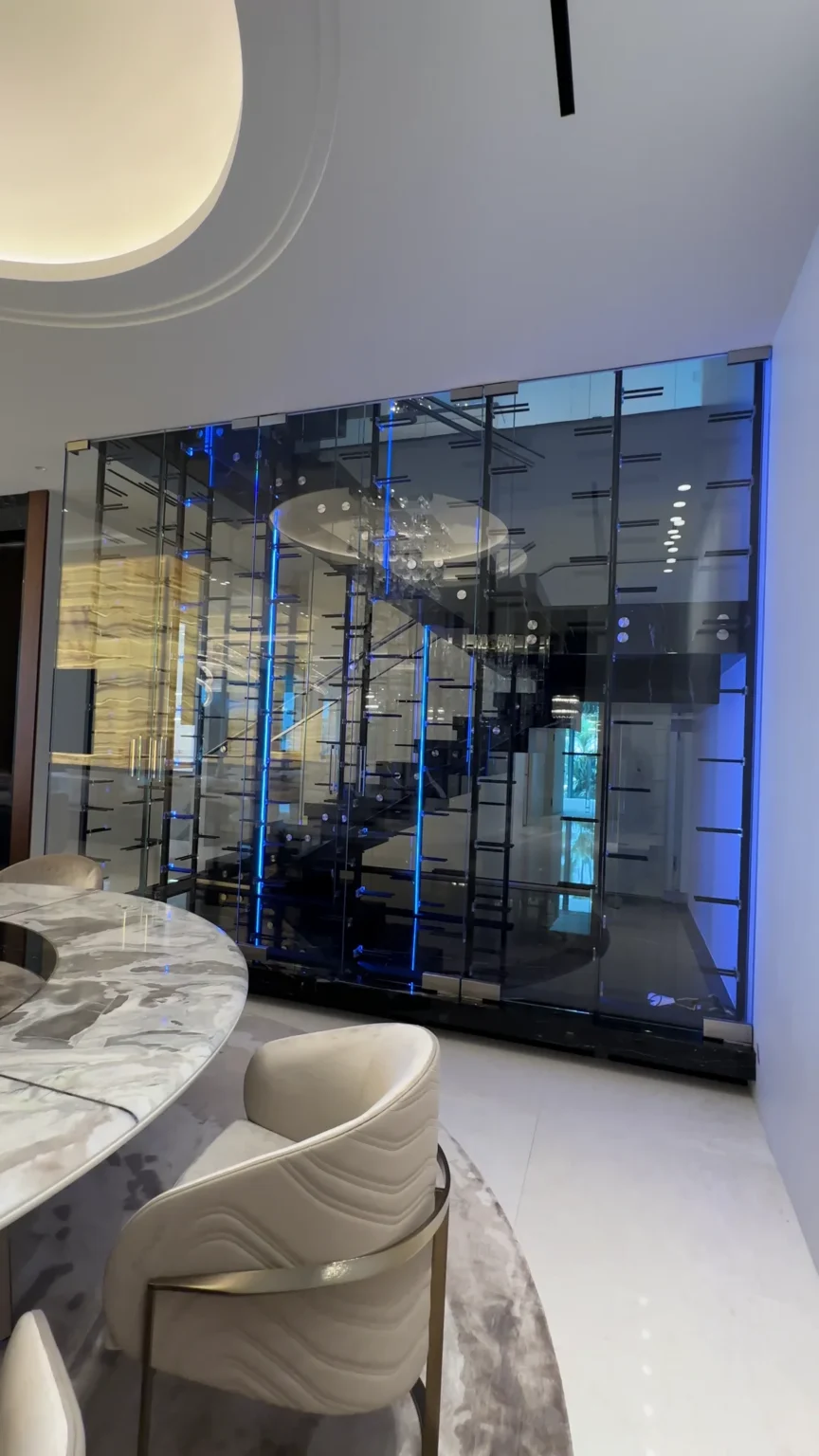 Glass wine wall with blue lighting by ACG Glass & Metals
