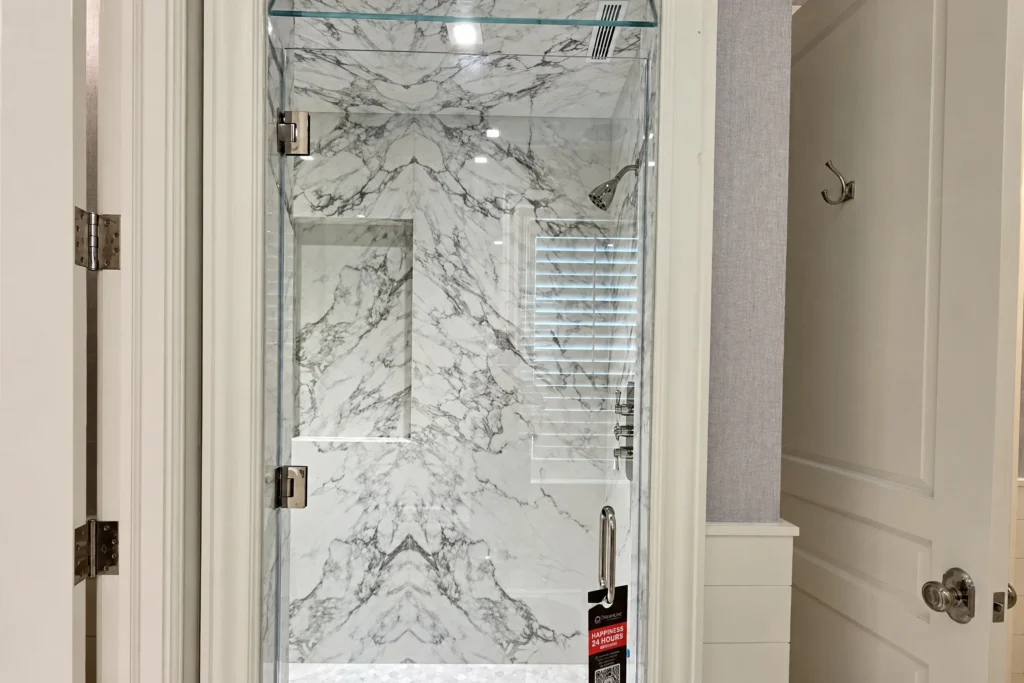 Low iron frameless glass shower door with polished nickel hardware by ACG Glass & Metals in Palm Beach