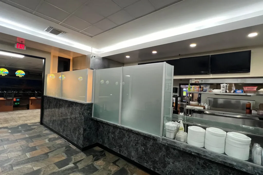 Acid etched glass partitions at the snack bar counter of Greenacres Bowl