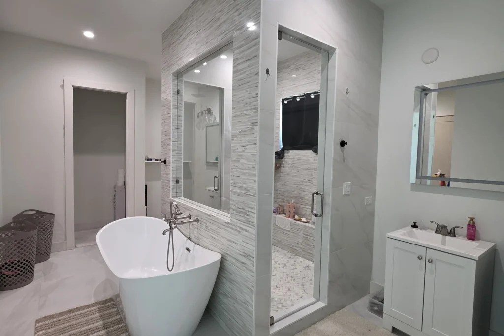Frameless clear glass shower enclosure with brushed nickel hardware, North Palm Beach