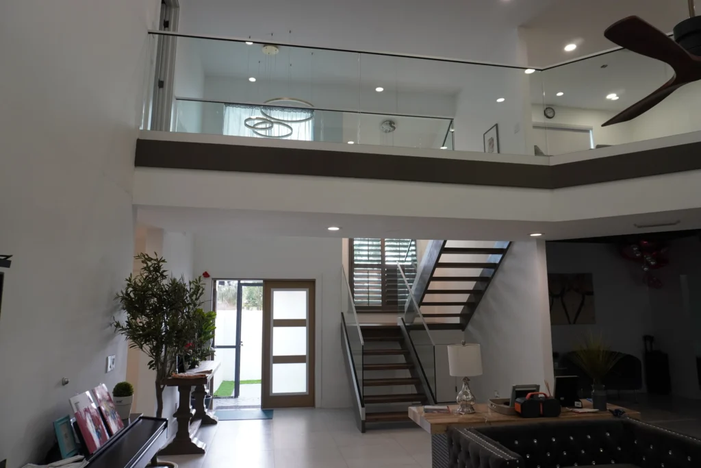 Interior glass railings on the upper landing and stair of a Boca Raton, FL home