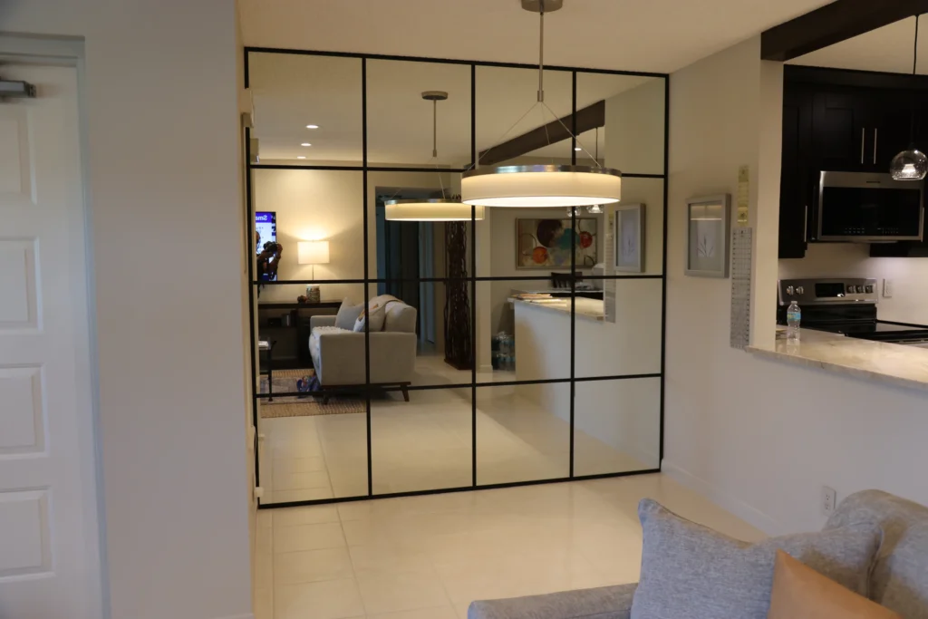 Floor to ceiling mirror wall with matte black aluminum grids in a West Palm Beach home