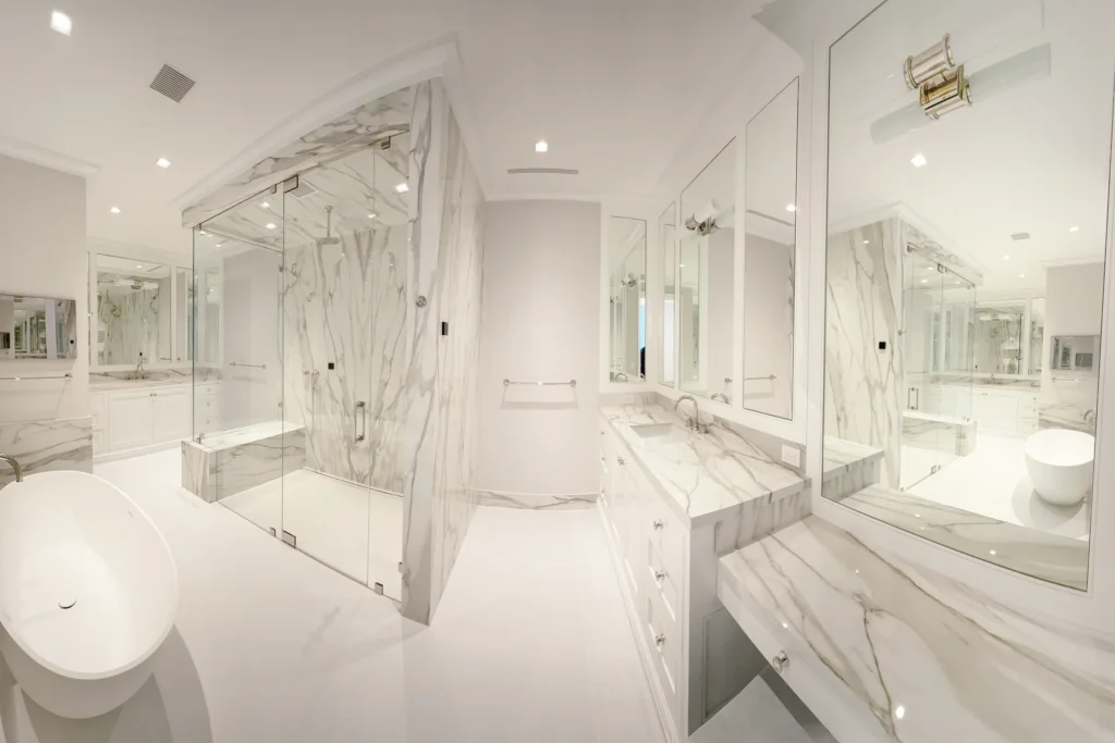 Frameless Starphire glass shower enclosure with polished nickel hardware at N Lake Way residence in Palm Beach, FL by ACG Glass & Metals