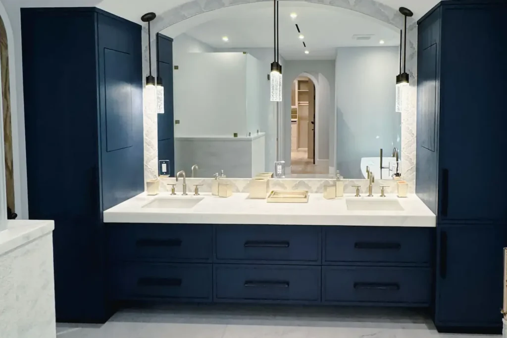 Custom vanity mirror in an arched niche over a navy double vanity, N Ocean Way Residence, Palm Beach