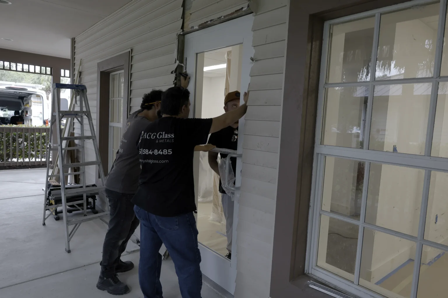 Glass crew installing an impact storefront door at Riverbend Family Dentistry, Jupiter