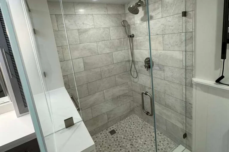 Frameless glass shower enclosures at a Seafarer Circle condo in Jupiter, FL