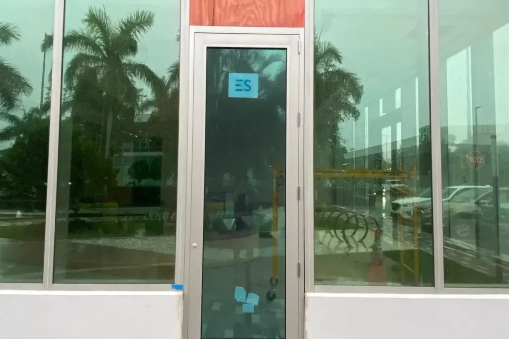 Impact storefront door with transom at Signor Sassi in Hallandale Beach by ACG Glass & Metals