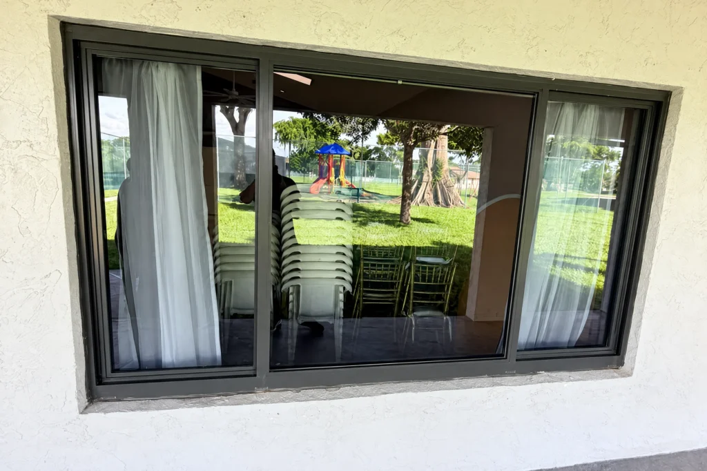 Gray tint impact glass replaced in a clubhouse window in West Palm Beach