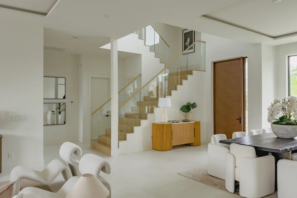 White oak waterfall staircase with a glass railing in a Boca Raton home