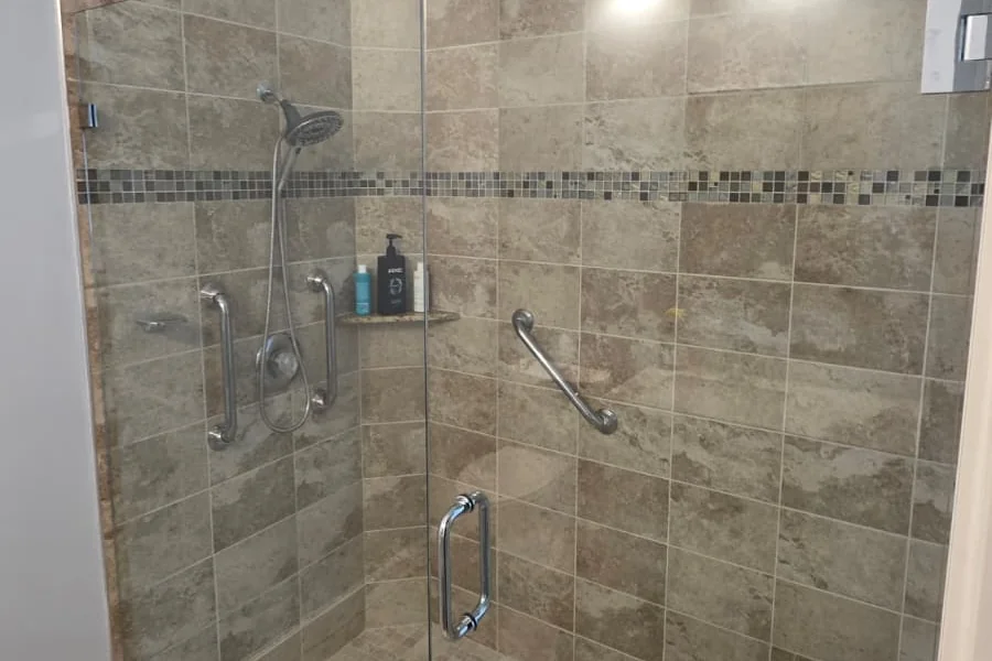 Frameless glass shower enclosure with polished chrome hardware, Wharton Way residence, West Palm Beach