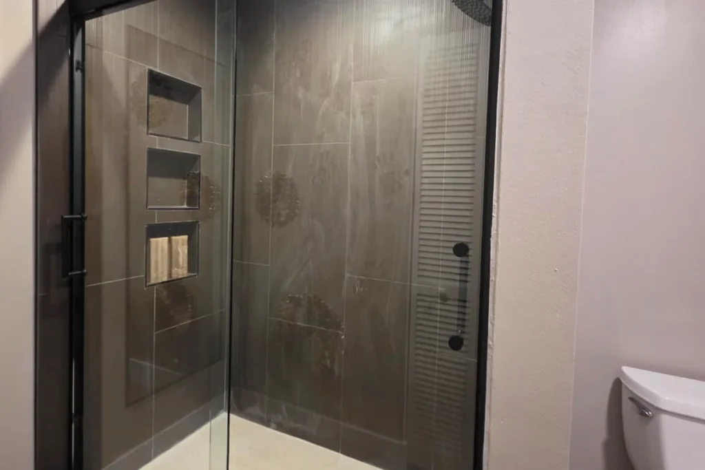 Matte black bypass sliding shower enclosure with clear glass, Palm Beach Gardens